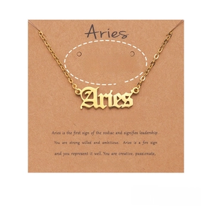 Detailed view of gold 18k plated Aries zodiac necklace with branded packaging card