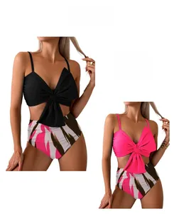 Detail of high waisted bikini with abstract stripe print and oversized bow tie top