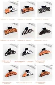 Close-up of Halloween hair claws featuring pumpkin and ghost prints on a white surface