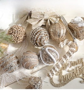 Detail of glittery champagne gold and silver Christmas ornaments with pine needles