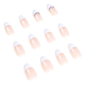 French press-on nails set with nude base, white tips, and sparkling rhinestones
