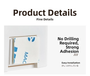Detail of wall-mounted razor holder showing adhesive backing for drill-free installation