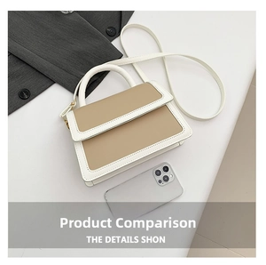 Detail of color-block beige and khaki rectangular crossbody bag with stitching and handle
