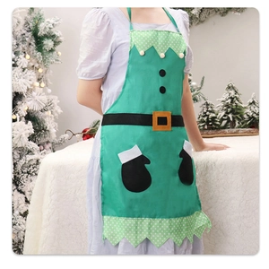 Christmas elf themed green kitchen apron worn by model in a snowy festive setting