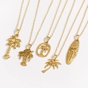 Detail of five gold stainless steel necklaces with palm tree and surfboard pendants