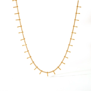 Polished gold stainless steel necklace with sleek vertical bar pendants on white background