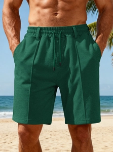 Close-up of men's dark green waffle texture beach shorts with drawstring elastic waist