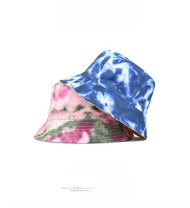 Detail of colorful tie-dye bucket hats in blue, green, and pink breathable cotton fabric