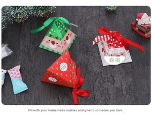 Three triangular Christmas gift boxes in red, green and white with festive patterns