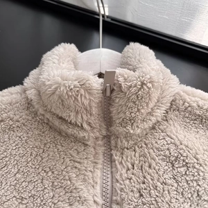 Women's warm cream sherpa fleece jacket with stand collar and zipper closure details