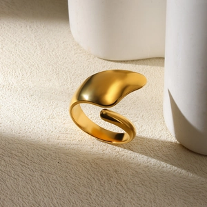Macro detail of gold organic curved ring with a modern matte finish and irregular shape