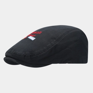 Detailed side view of black cotton beret with red letter embroidery and vintage style