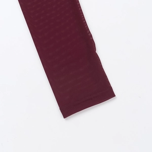 Detail of burgundy mesh long sleeve showing fine fabric texture and neat seam stitching