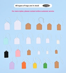 Detail view of assorted multi-color paper price tags in various shapes with strings