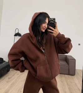 Detail of dark brown hooded zip-up sweatshirt and thick joggers fabric texture