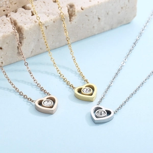 Three heart-shaped zircon pendant necklaces in rose gold, gold, and silver finishes