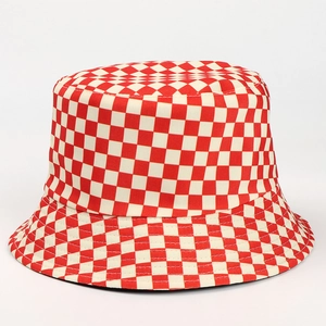 Detail of red and white checkered pattern on a reversible bucket hat for sun protection