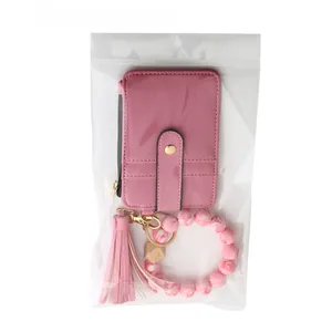 Pink faux leather card holder with tassel and marble silicone bead bracelet in opp bag