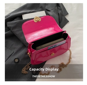 Detail showing bright pink patent leather bag interior with gold heart lock and chain