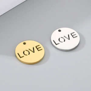 Detail of round stainless steel gold and silver pendants with LOVE cut-out design