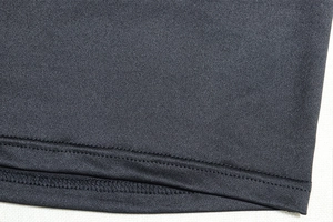 Macro view of tight-knit fabric texture and double-needle stitching on black crop top set