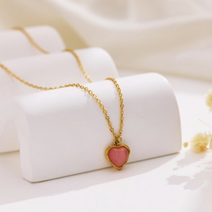 Elegant gold titanium steel necklace featuring a sweet pink heart gemstone pendant