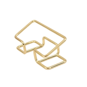 Minimalist gold metal business card holder with a sleek geometric wire structure