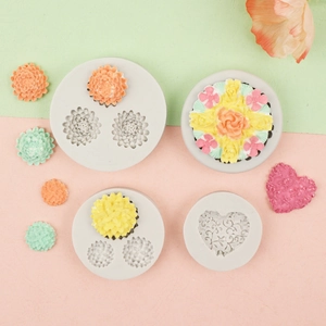 Silicone molds for rose and daisy flower cake decorations on a soft pastel background