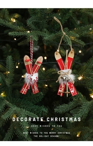 Detail of wooden Christmas sled ornaments with bells and plush trim on a tree