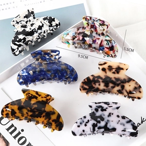 Detailed view of 6-piece acetate hair claw clips in various patterns with dimensions 9.5cm x 5.5cm