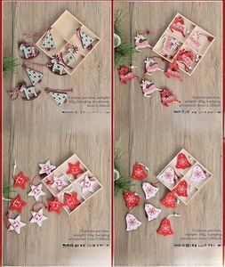 Detail of laser-cut wooden Christmas ornaments set in a wooden storage box with red strings