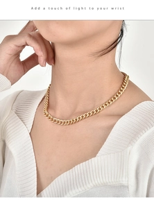 Macro detail of 18K gold plated Cuban chain necklace with sparkling zircon pavé setting