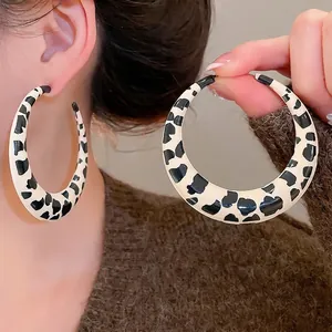 Chic cow print round hoop earrings for women with a sleek polished finish