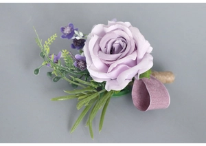 Close-up of lavender silk rose boutonniere with velvet ribbon and jute rope wrap