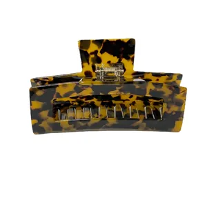 Elegant tortoiseshell claw clip with polished finish and strong metal spring for hair