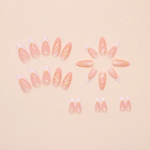 Detail of pink French press-on nails with white flowers and golden star patterns
