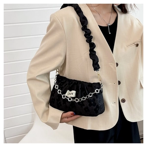 Detail showing black floral jacquard texture with silver flower chain and ruched strap