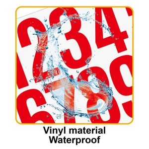 Macro shot of waterproof red vinyl number stickers showing water droplets on the surface