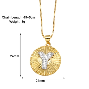Detail of 18k gold plated letter Y pendant necklace with sunburst pattern and stones