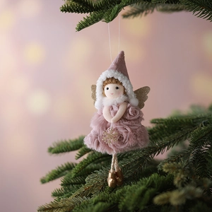 Pink plush Christmas angel pendant with golden sequin wings hanging on a tree