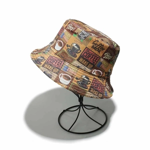 Detailed view of a retro coffee printed bucket hat on a black metal wire display stand