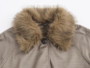 Close-up of brown checkered fabric texture with soft faux fur collar and black button