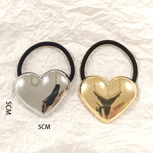 Detailed view of silver and gold heart hair ties with 5cm x 5cm dimensions shown