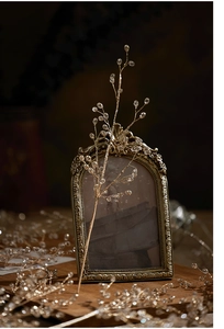 Close-up of golden beaded branch with transparent crystal beads for festive window decor