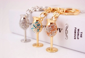 Detailed shot of sparkling rhinestone wine glass keychains in gold and silver finishes