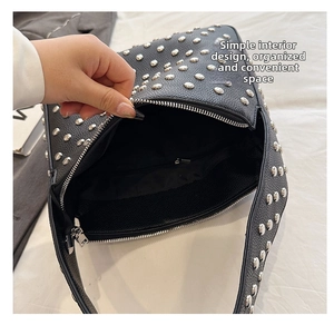 Top view of the spacious inner compartment of the black studded leather shoulder bag