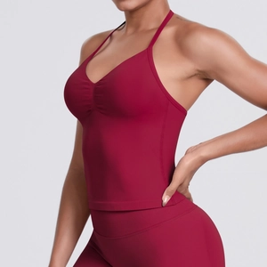 Detail of dark red seamless yoga top featuring halter neck and ruched chest design