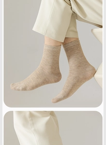 Detailed knit texture of vintage mid-calf men's cotton socks in light oatmeal color