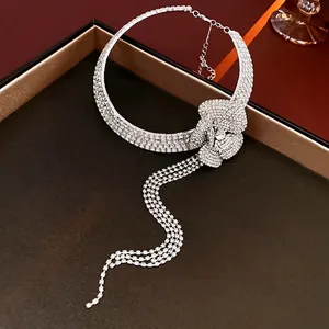 Luxury rhinestone flower choker necklace with long tassel fringe on dark display