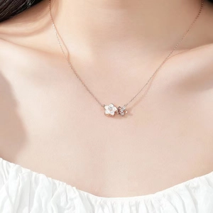 Rose gold cherry blossom necklace with white shell and zircon flowers on model